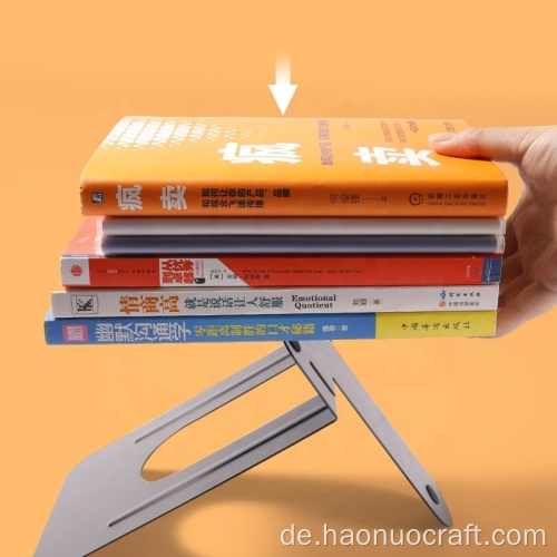 Der Bücherständer aus Metall trennt das Bücherregal. Einfache und kreative Buchstütze wird auf dem Tisch für Studenten verwendet